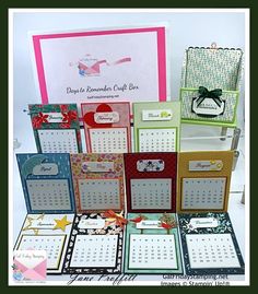 a table topped with lots of different types of cards and calendars on top of each other