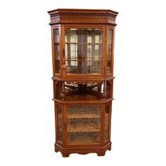 an antique wooden display cabinet with glass doors