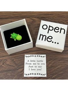 an open me box with a small turtle in it and a note inside the box