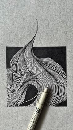 a pen sitting on top of a piece of paper next to an image of wavy hair