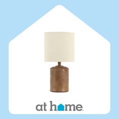 a lamp that is sitting on top of a blue and white background with the words at home above it