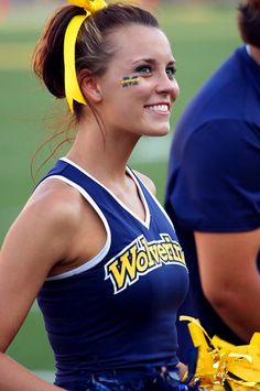 a cheerleader is smiling for the camera