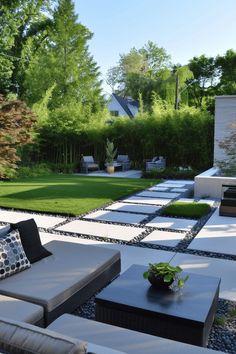 an outdoor living area with couches and tables