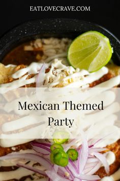 mexican themed party with limes, onions and sour cream on the side in a black bowl