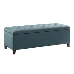 a blue bench with wooden legs and a tufted upholstered cushion on it