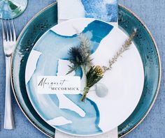 a blue and white plate with a place setting on it