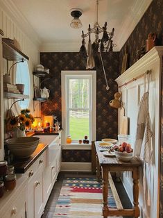 a kitchen filled with lots of counter top space next to a sink and stovetop oven