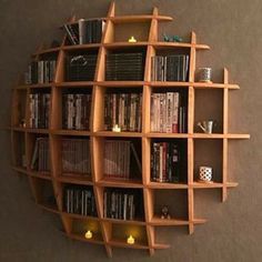 a book shelf with many books on it and some lights in the corner next to it