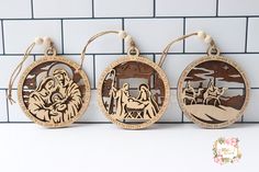 three wooden ornaments depicting the birth of jesus