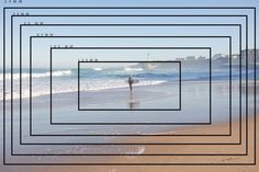 a person standing in the water on top of a sandy beach next to the ocean