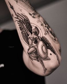 a man's arm with tattoos on it and an angel holding a clock in his hand