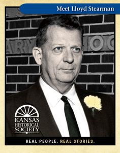 a black and white photo of a man in a suit with a flower on his lapel