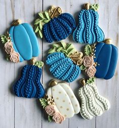 several decorated cookies sitting on top of a wooden table