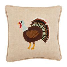 a decorative pillow with a turkey embroidered on the front and sides, sitting on a white background