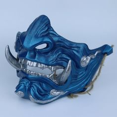 Carefully sculpted to resemble an Oni a fearsome demon mask originating from Japanese folklore our Oni Demon Japanese Mask is ideal for cosplay enthusiasts, venturing into the mysterious world of samurai. Details: We have padded the inside of the mask for your facial comfort. The mask can stay on your face for a long time in the activity you use. It does not cause pain on your face and you can breathe comfortably. It is very robust in your activities with its high filling and extra layer thickne Warrior Style Masks For Cosplay And Masquerade Events, Warrior Masks And Prosthetics For Halloween, Samurai Mask For Halloween, Samurai Style Halloween Mask, Samurai Halloween Mask, Halloween Samurai Mask And Prosthetics, Warrior Style Masquerade Mask For Halloween, Blue Fantasy Costume Accessories For Fantasy Events, Samurai Masks For Halloween Cosplay