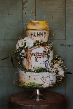 a winnie the pooh birthday cake with flowers on top