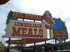 a large sign for some kind of restaurant called lumber jack meals and more park exit