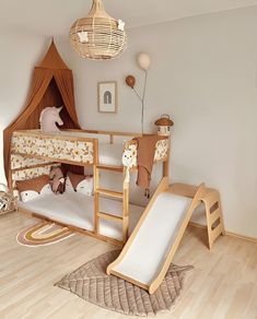 a child's bedroom with bunk beds and slide