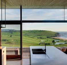 an open kitchen with a view of the ocean and golf course from it's windows