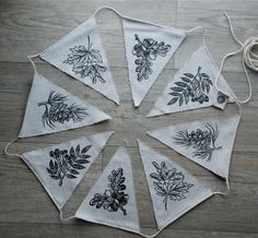 four tea towels with black and white designs on them, tied together in a circle