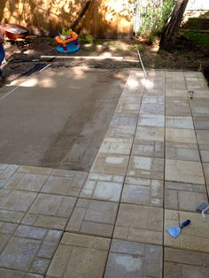 an empty backyard with some tools laying on the ground