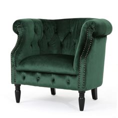 a green velvet chair with studded trimmings on the arms and back, in front of a white background