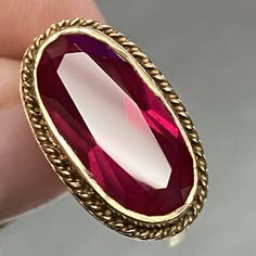 This Vintage Filigree Ring Is A Stunning Piece Of Jewelry That Will Add A Touch Of Elegance To Any Outfit. The Ring Is Made Of 10k Gold And Features A Beautiful Oval-Shaped Red Stone That Is Sure To Catch The Eye. The Deco Geometric Cut Of The Stone Adds A Unique Touch That Makes This Ring Truly Special. The Ring Is A Size 6 And Is Designed For Women. It Is Perfect For Those Who Appreciate Vintage And Antique Jewelry, And Would Make A Great Addition To Any Collection. The Brand Of The Ring Is Fi Oval Diamond Cut Ruby Ring, Elegant Faceted Ruby Ring In Yellow Gold, Elegant Yellow Gold Faceted Ruby Ring, Elegant Faceted Ruby Ring For Formal Occasions, Elegant Formal Faceted Ruby Ring, Red Faceted Jewelry For Formal Occasions, Red Oval Faceted Jewelry, Red Faceted Oval Jewelry, Formal Red Faceted Jewelry