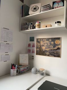 a white desk topped with lots of clutter