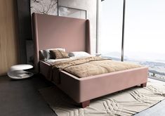 a bed with a pink headboard and foot board in front of a large window