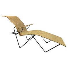 an outdoor chaise lounge chair made out of wicker and metal frame with wheels