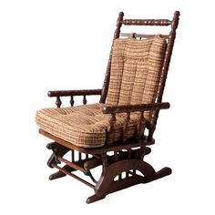 a wooden rocking chair with wicker seat and footrests on an isolated white background