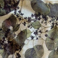 an image of leaves and flowers on fabric