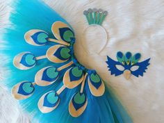 a blue and gold peacock costume with matching headbands, hair combs and pins