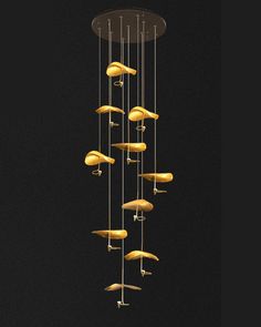 a chandelier with yellow lights hanging from it's sides in a dark room