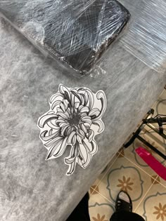 an image of a flower sticker on the back of a car seat with its lid down