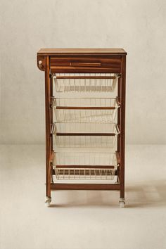 a small wooden shelf with baskets on it's sides and two shelves underneath the shelf