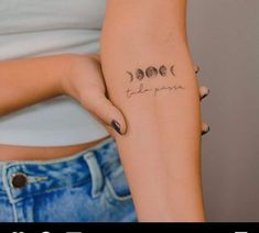 a woman's arm with three phases of the moon tattooed on her left side