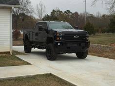 a black truck parked in front of a house