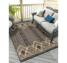 an outdoor area rug is shown on the porch