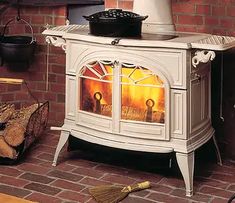 an old fashioned stove with the door open and fire burning in it's center