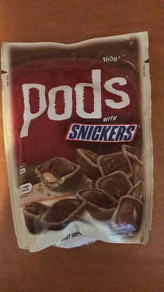 a bag of pods with snickkers sitting on a table