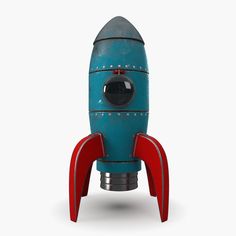 a blue and red toy rocket ship sitting on top of a white surface