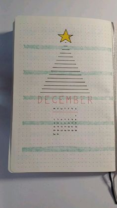 an open notebook with a christmas tree on it