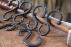 several metal hooks are sitting on top of a chair