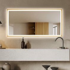 a bathroom sink under a large mirror with lights