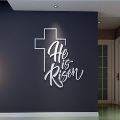 there is a cross on the wall and it says he is risen in white letters