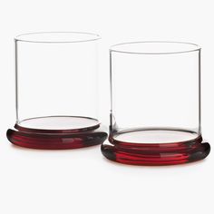 two red glass vases sitting next to each other