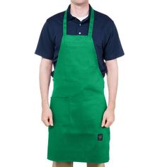 a man in an apron is standing with his hands on his hips and looking at the camera