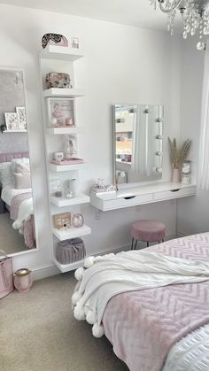 a bedroom with a bed, desk and mirror on the wall next to a window