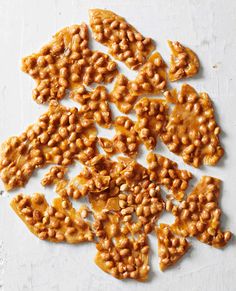 several pieces of peanut brittle on a white surface